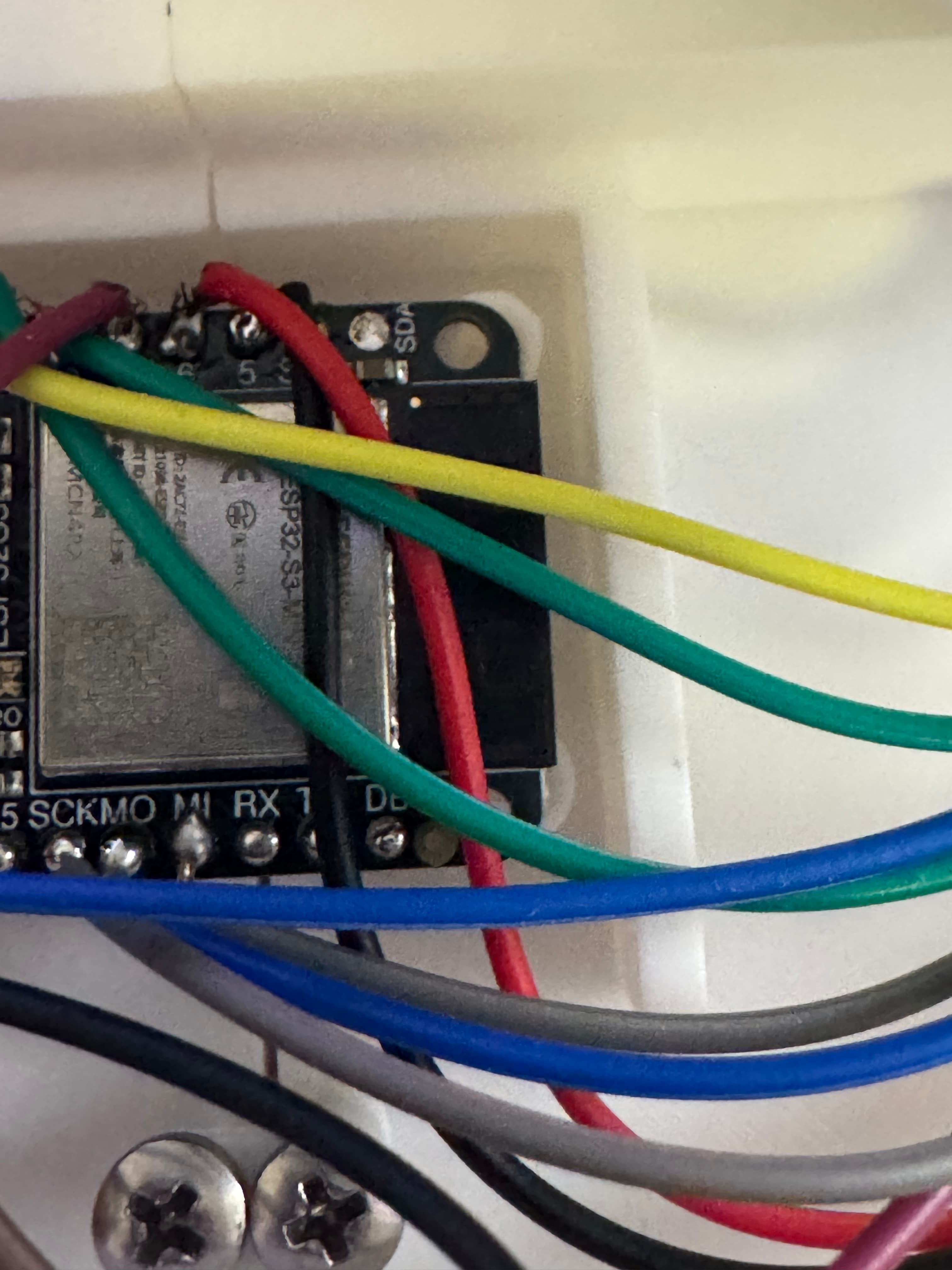 Close-up of the ESP32 Feather wiring inside the enclosure